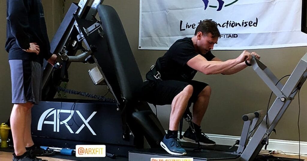 A person using an ARX fitness machine for strength training.